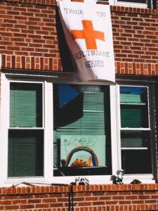 A brick home with a white banner that reads, "Thank You Healthcare Heroes."