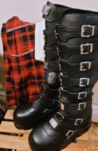 My tall black Demonia boots, a red tartan skirt with chains, and a white button up blouse.