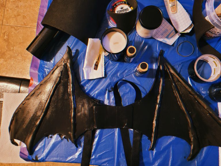 My 2nd attempt bat wings dry on a table next to a bunch of art supplies